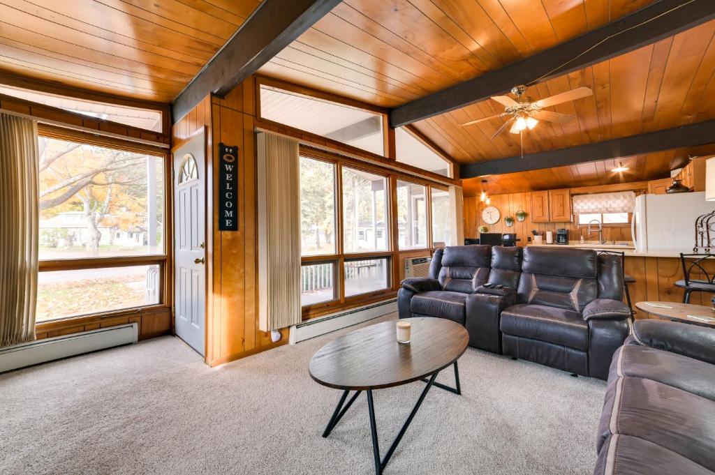 a living room with a couch and a table at Otsego Lake Getaway with Community Boat Ramp! in Gaylord