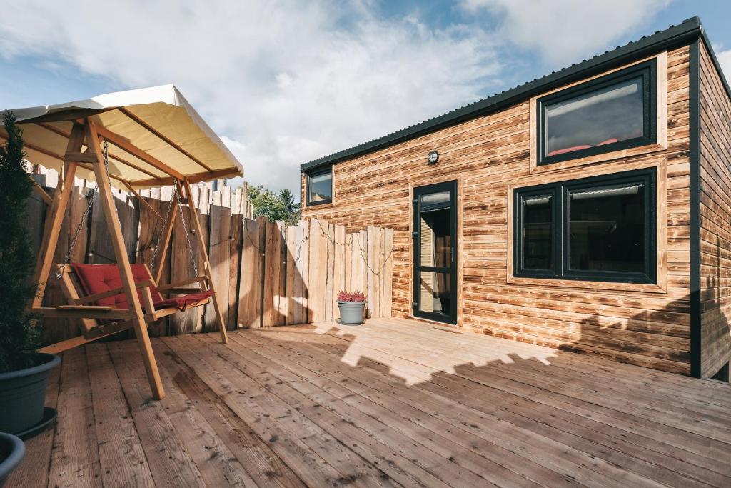 a wooden deck with a house under construction at Idyllisches Tiny House mit Sauna in Löbau