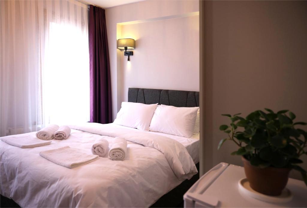 a bedroom with a bed with towels on it at NarPera Taksim Boutique Hotel in Istanbul