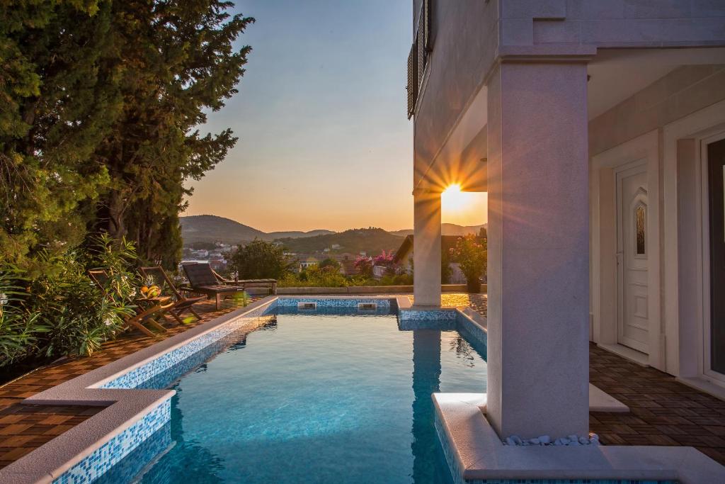 a swimming pool in the backyard of a house at Villa Stella Adriatica in Slano