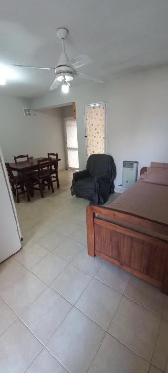 a bedroom with a bed and a table and chairs at DEPARTAMENTO 2 ambientes in Colón