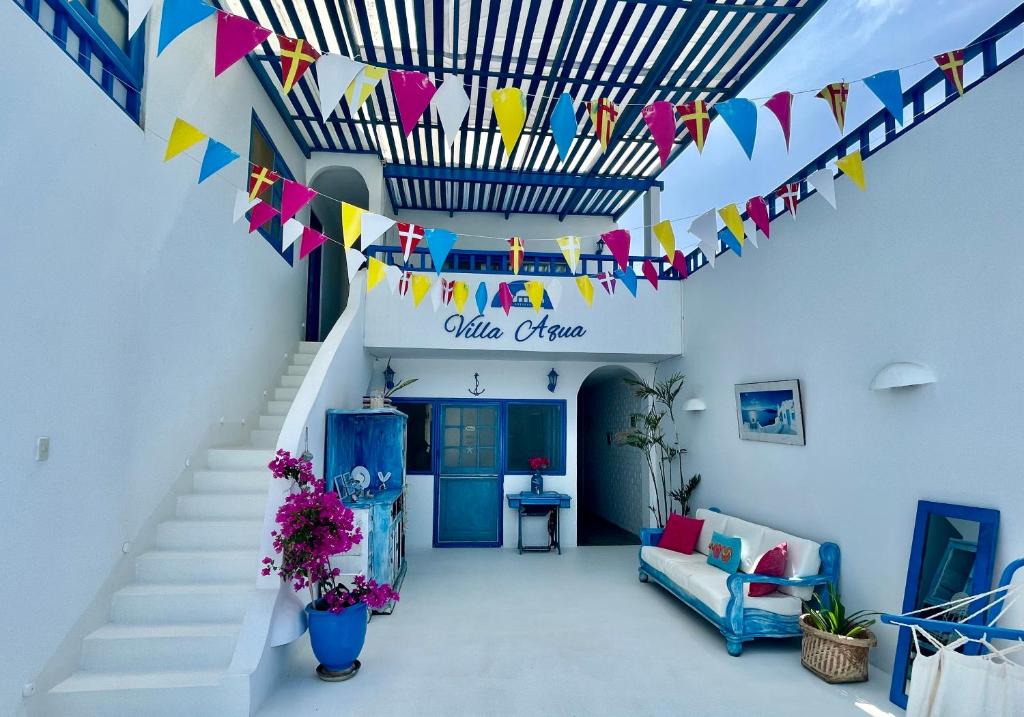 a room with a staircase with flags and flowers at Villa Aqua Boutique Vichayito in Vichayito