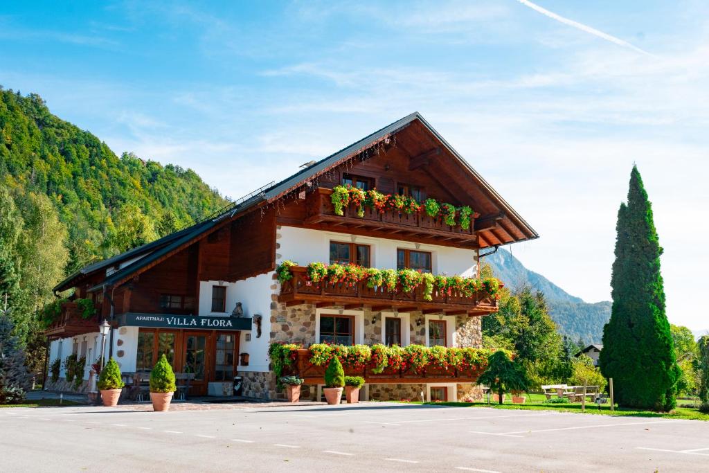 a building with flower boxes on the front of it at Apartments in Villa Flora in Kranjska Gora