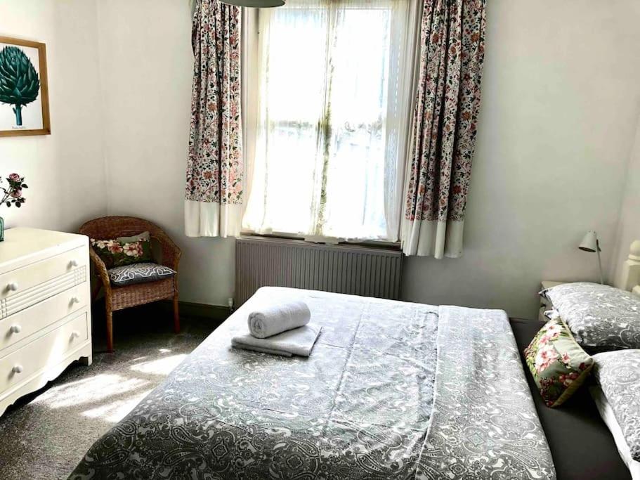 a bedroom with a bed and a window at Heart of Hebden in Hebden Bridge
