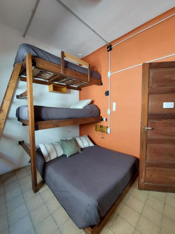 a bedroom with two bunk beds and a closet at Hostel Ruta76 in Sierra de la Ventana