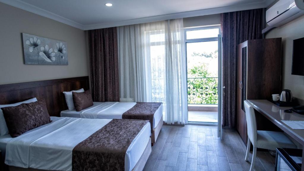 A bed or beds in a room at MAÇA OTEL