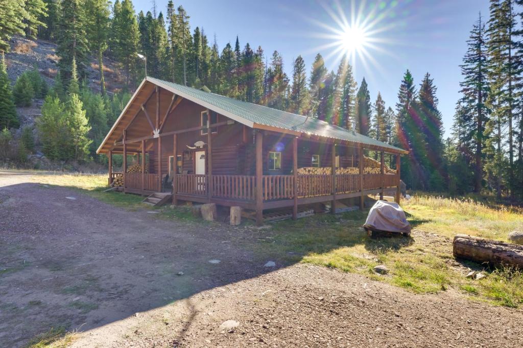 a large wooden cabin in the middle of a forest at Philipsburg Log Cabin - Direct Ski Lift Access! in Georgetown