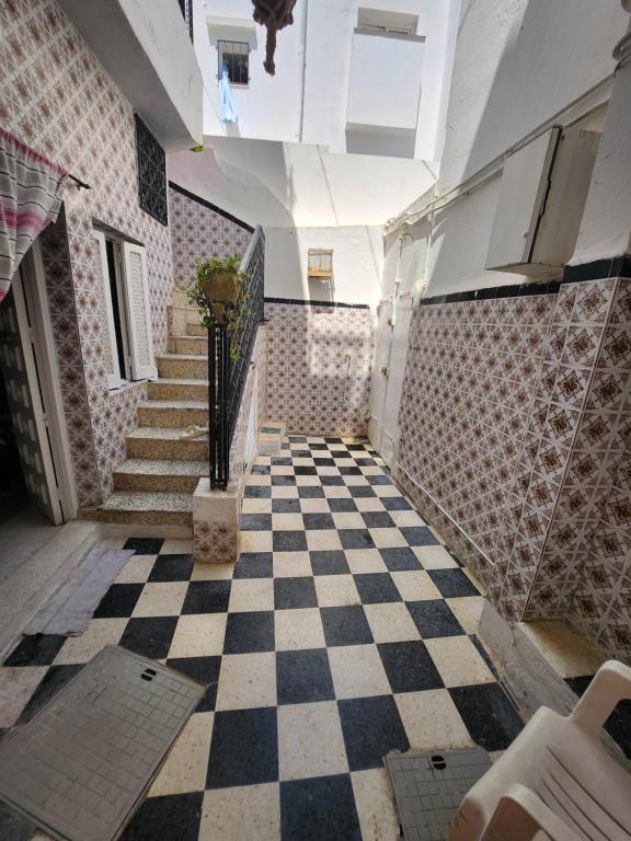 un corridoio con pavimento a scacchi in un edificio di Villa Hammamet a Hammamet