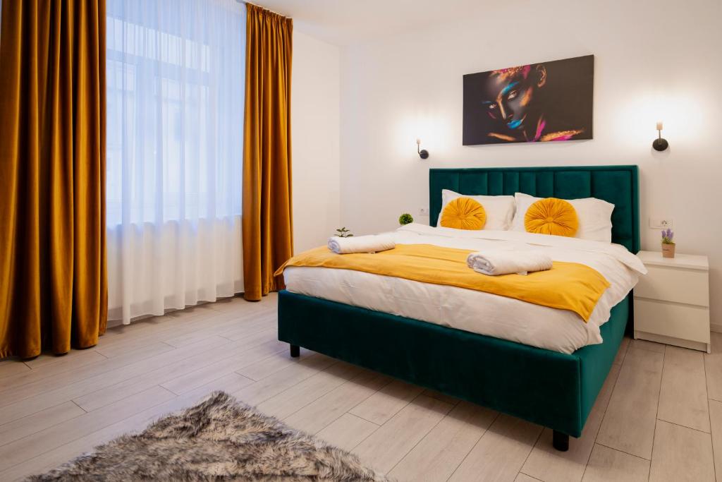 a bedroom with a large green bed with yellow sheets at Casa Paul in Braşov
