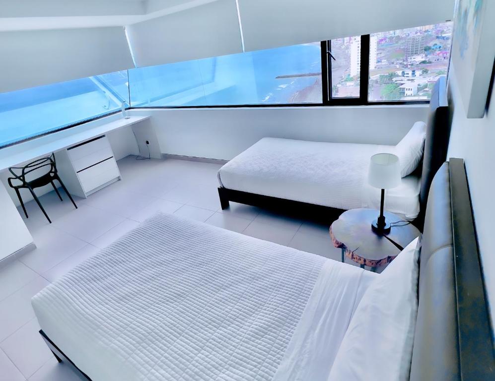 A bed or beds in a room at The Best Luxury Penthouse - Beach View