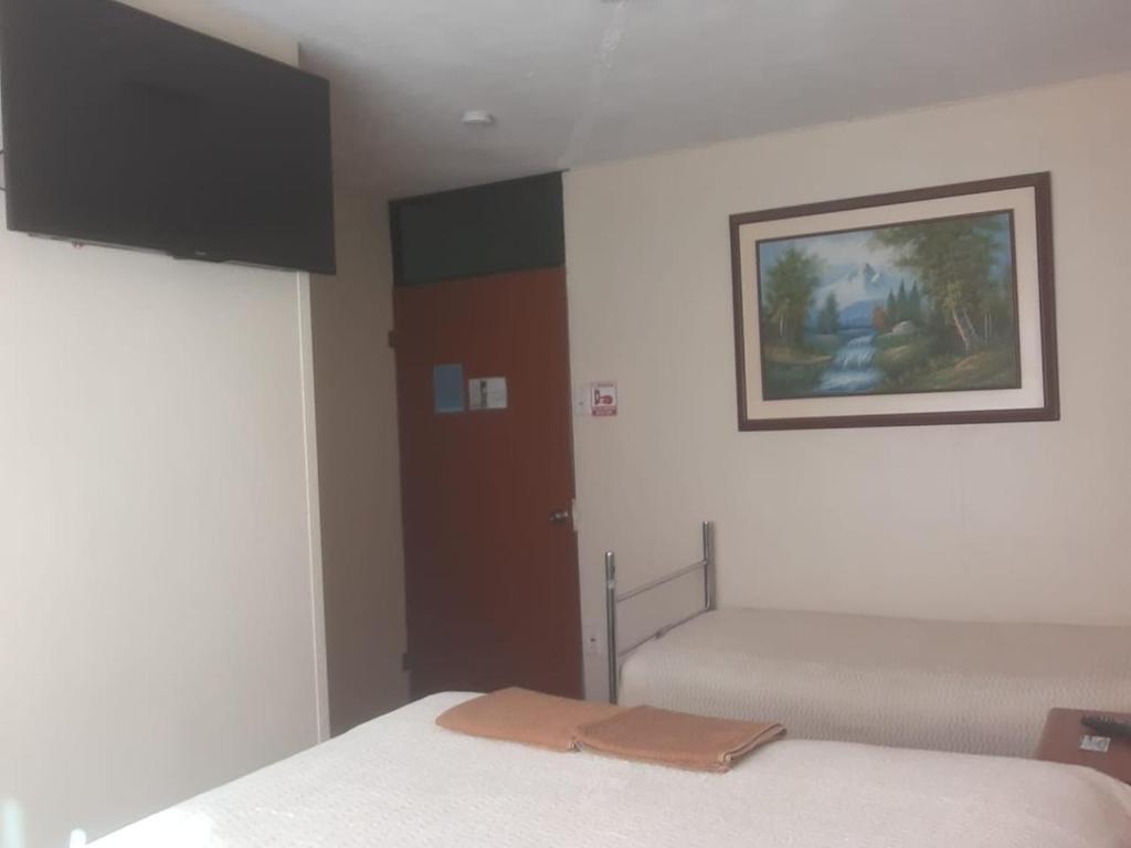 Postel nebo postele na pokoji v ubytování Hostal El Auténtico Diamante
