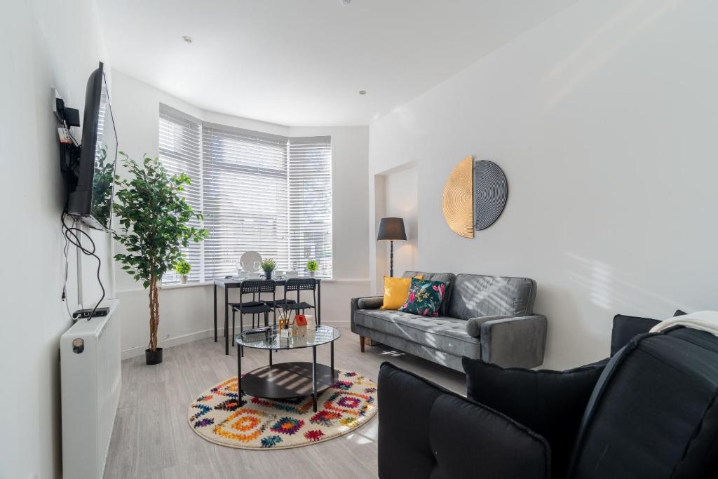 a living room with a couch and a table at Dyke Apartment in Uddingston