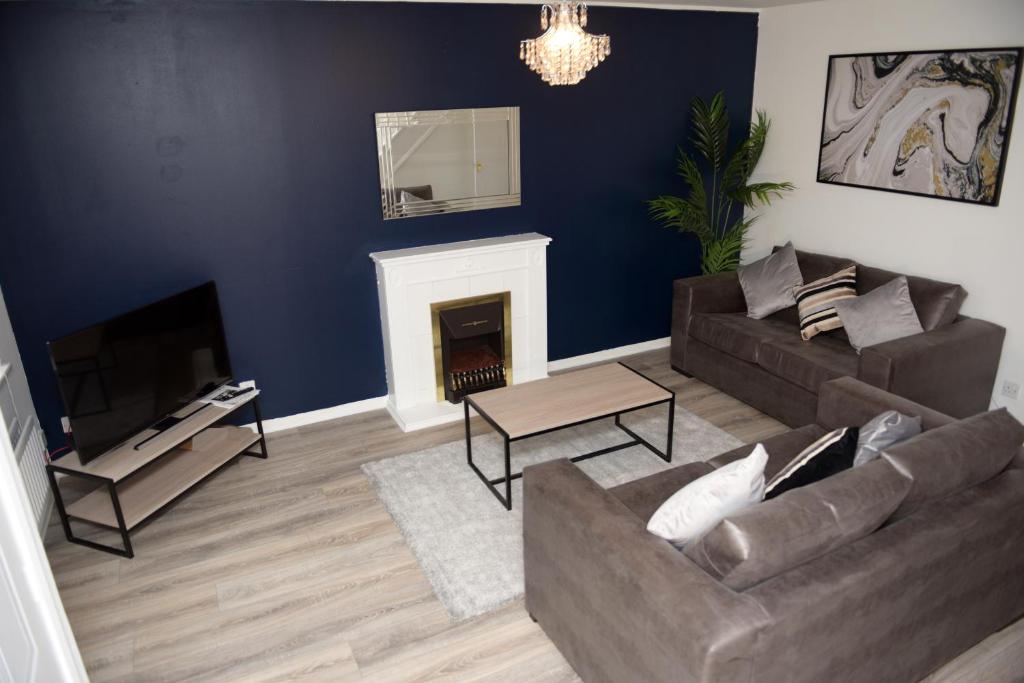 a living room with a couch and a fireplace at Gorgeous 3 bed house in Bristol in Bristol