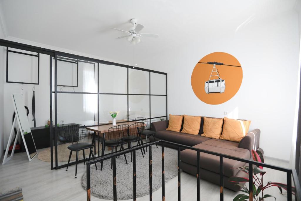 a living room with a couch and a table at Kutaisi Heritage - Modern House in Historic District in Kutaisi