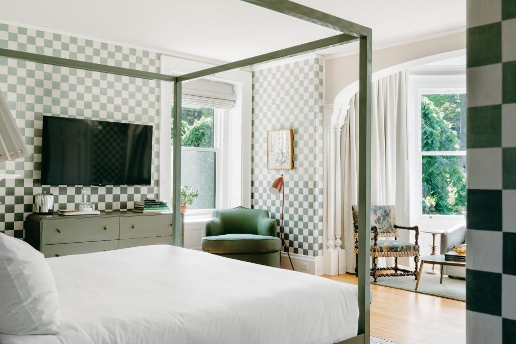 a bedroom with a bed and a tv in a room at The Norumbega Inn in Camden