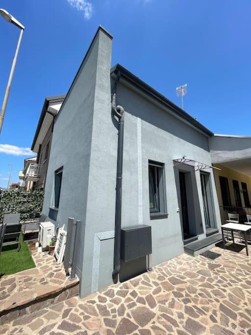 a gray building with a patio in front of it at Villa Girasole in Cesano Maderno