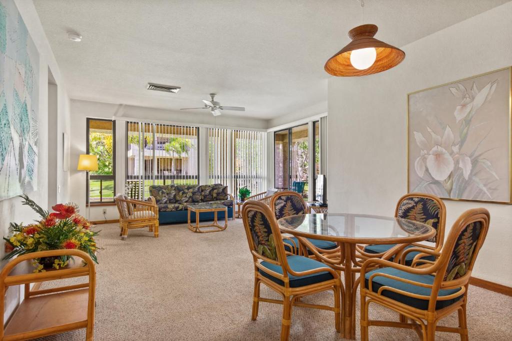 a living room with a table and chairs at Shores at Waikoloa 112 - MCH in Waikoloa