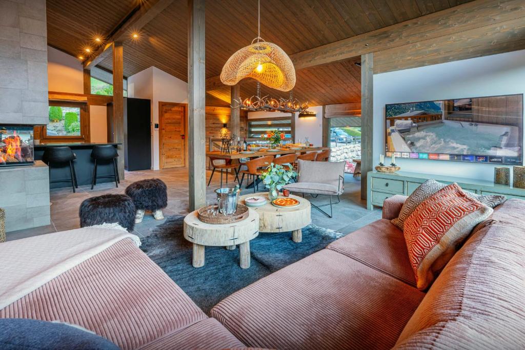 a living room with a couch and a table at Chalet Amarou - OVO Network in Châtel