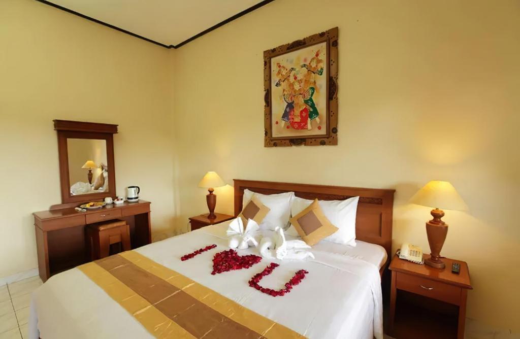 Postel nebo postele na pokoji v ubytování Bali Sandy Resort