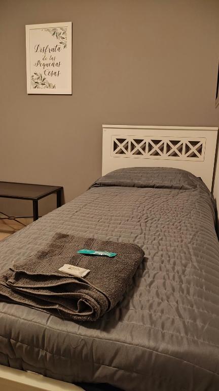 a bed with a blanket on top of it at depto por dia in General Roca