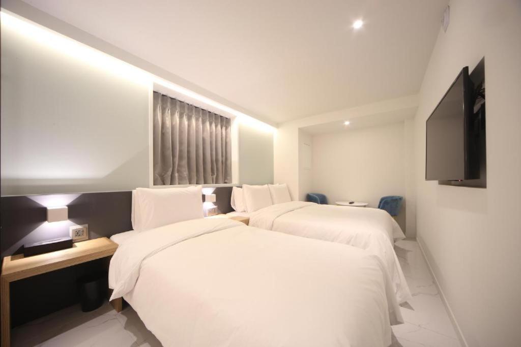 Postel nebo postele na pokoji v ubytování Busan Seomyeon Business Hotel J7