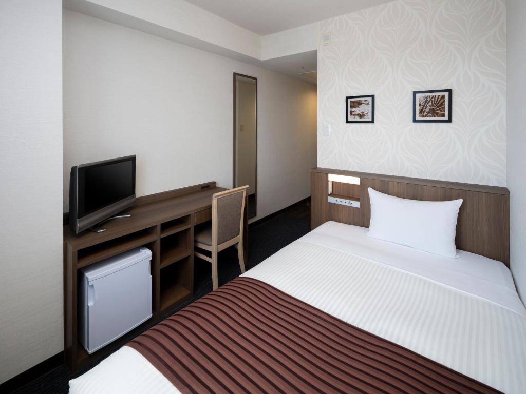 Postel nebo postele na pokoji v ubytování Art Hotel Joetsu