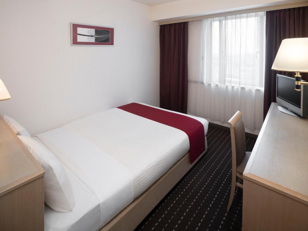 Postel nebo postele na pokoji v ubytování Art Hotel Joetsu