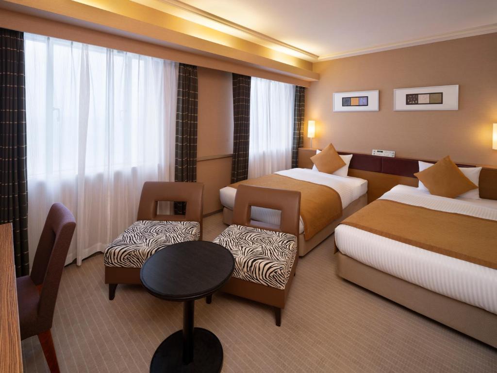 Postel nebo postele na pokoji v ubytování Art Hotel Joetsu
