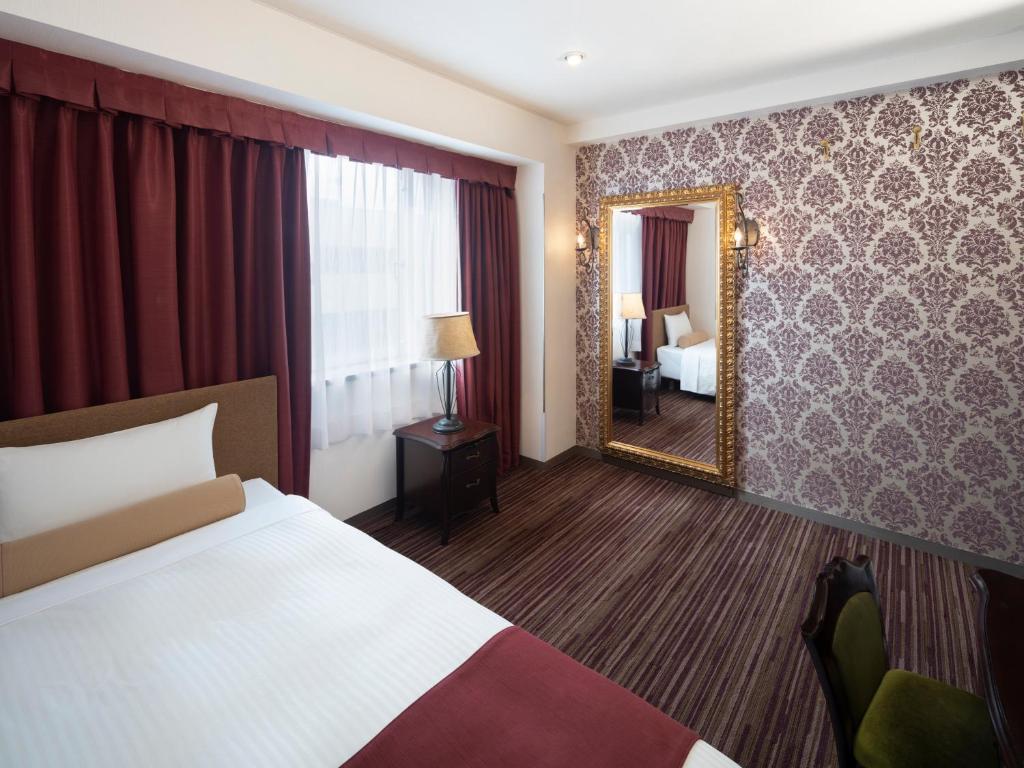 Postel nebo postele na pokoji v ubytování Art Hotel Joetsu