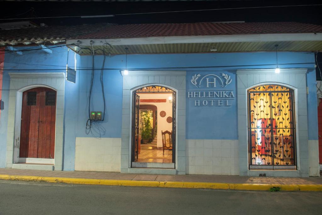 un edificio azul con tres puertas en una calle en Hotel Hellenika en León