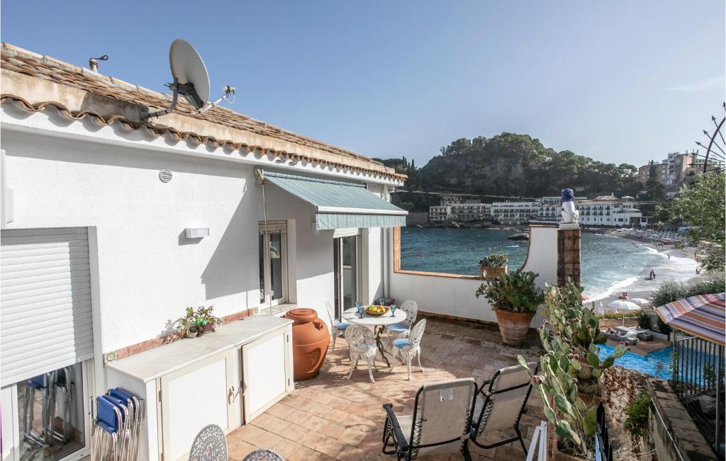 a balcony of a house with a view of the water at Mazzaro in Taormina