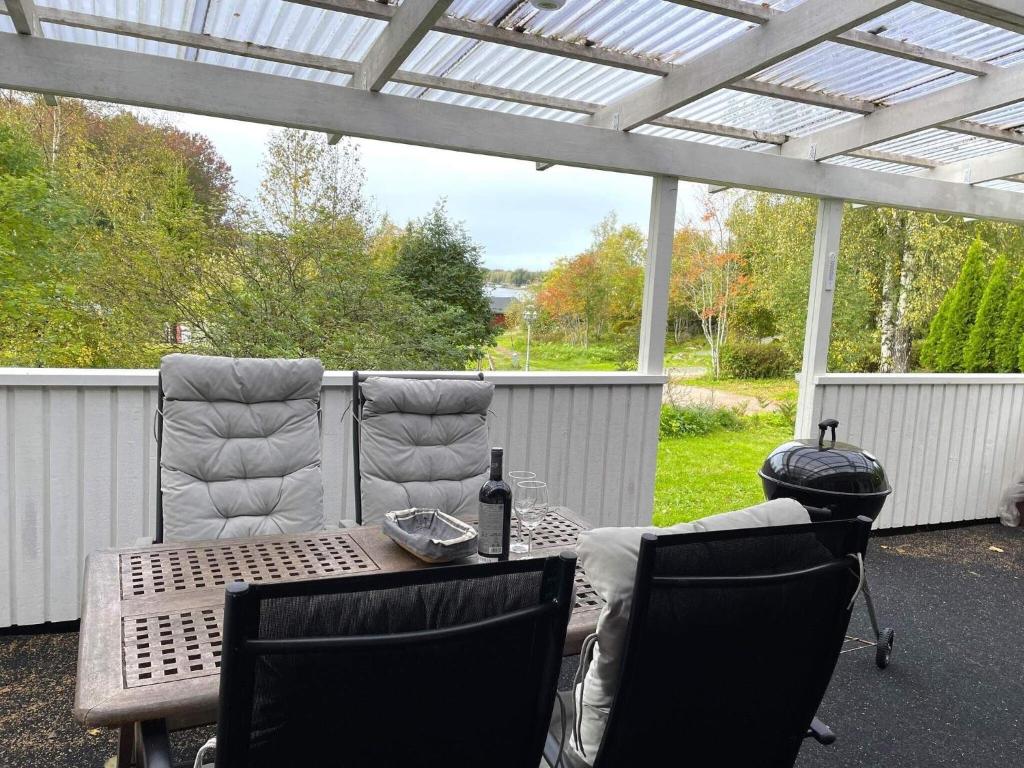 a patio with a table and chairs and a pergola at Holiday home SURAHAMMAR in Surahammar