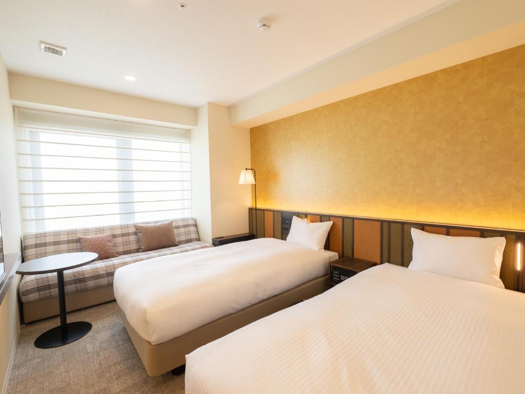 Postel nebo postele na pokoji v ubytování Loisir Hotel Kyoto Toji