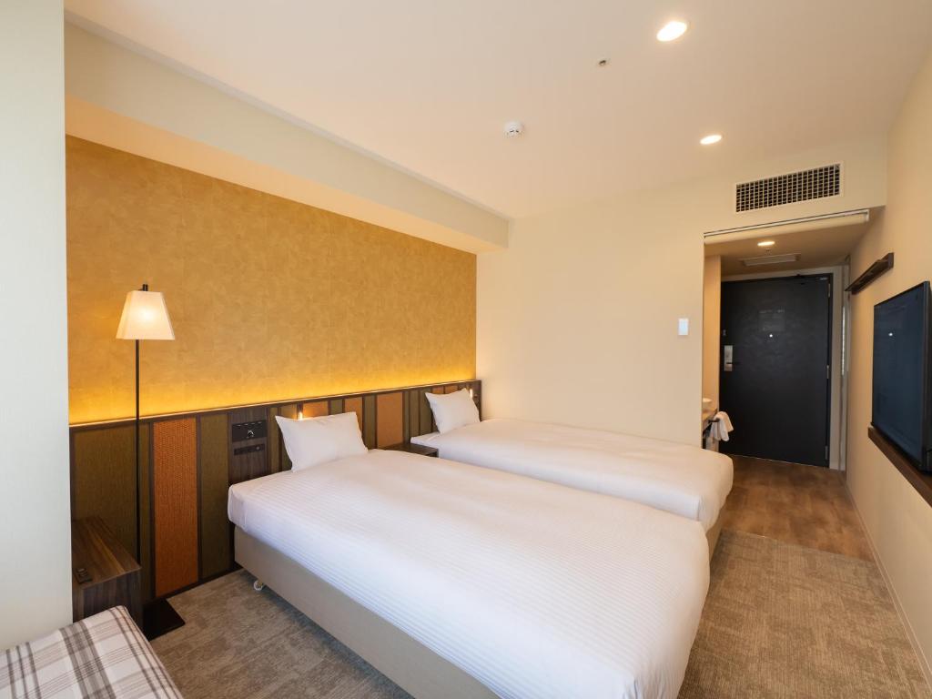 Postel nebo postele na pokoji v ubytování Loisir Hotel Kyoto Toji