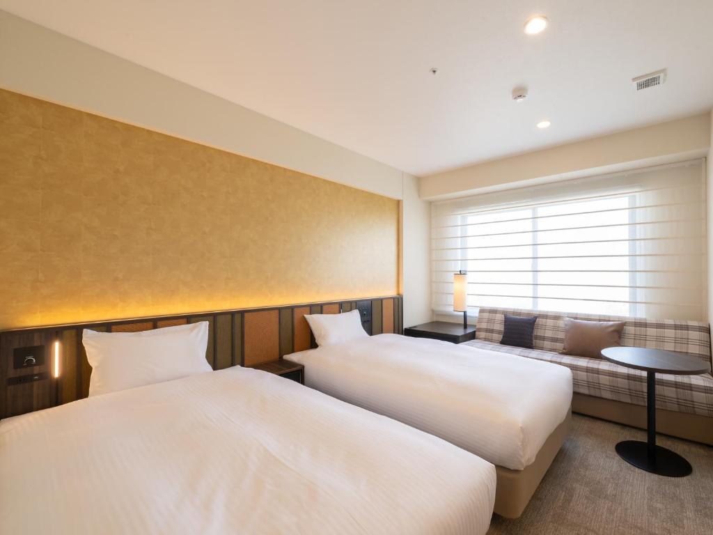 Postel nebo postele na pokoji v ubytování Loisir Hotel Kyoto Toji