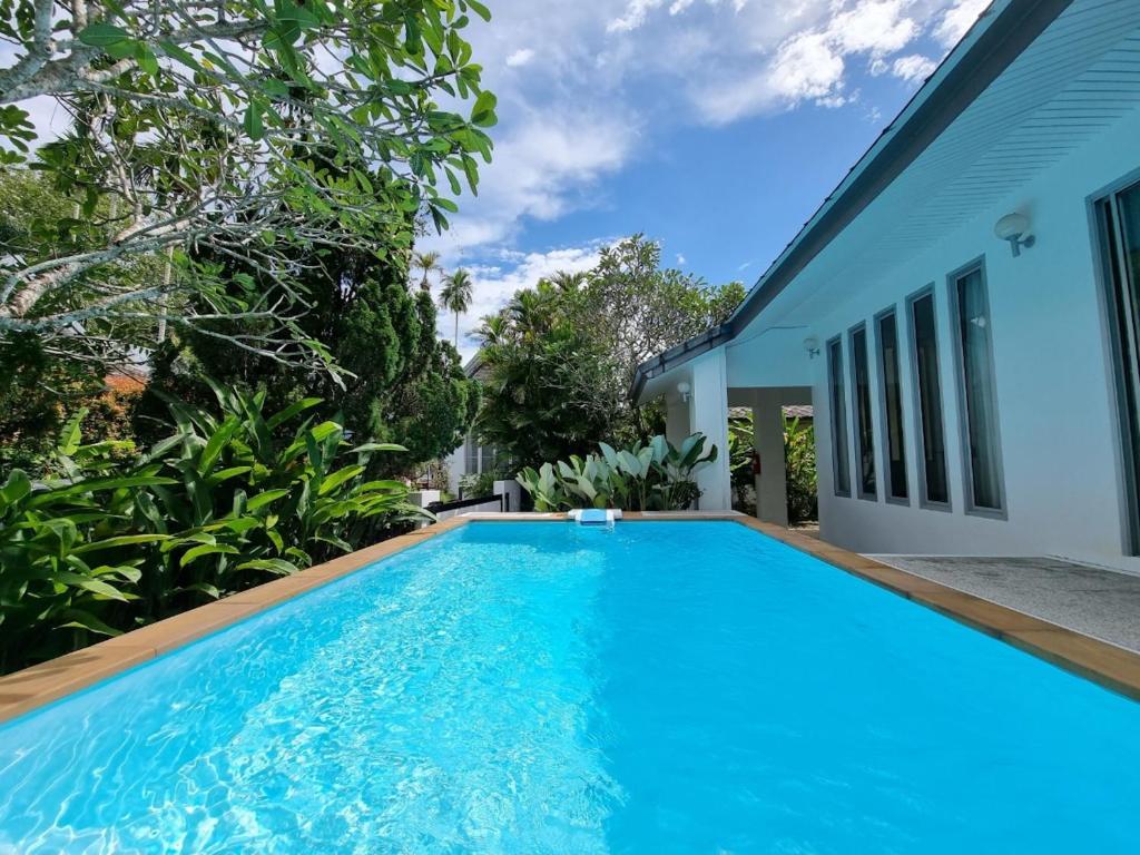 a swimming pool in front of a house at Baan Gecko in Ao Nang Beach