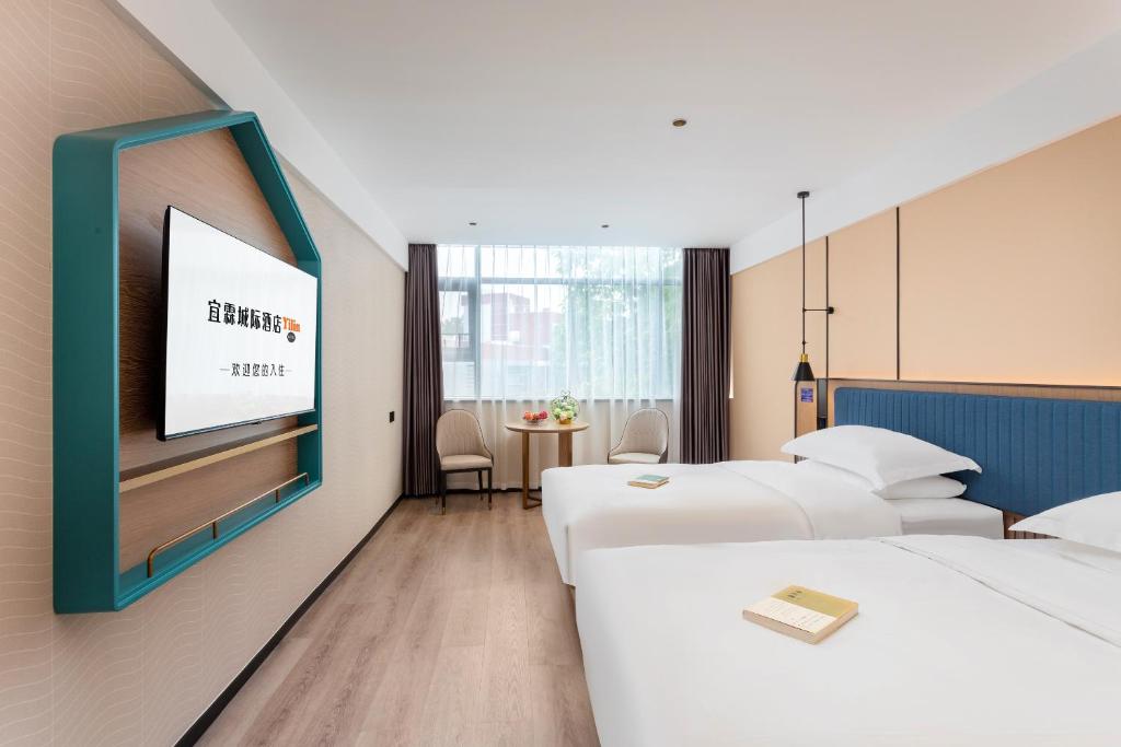 Postel nebo postele na pokoji v ubytování Guangzhou Yilin Hotel - Xiaogang metro Store