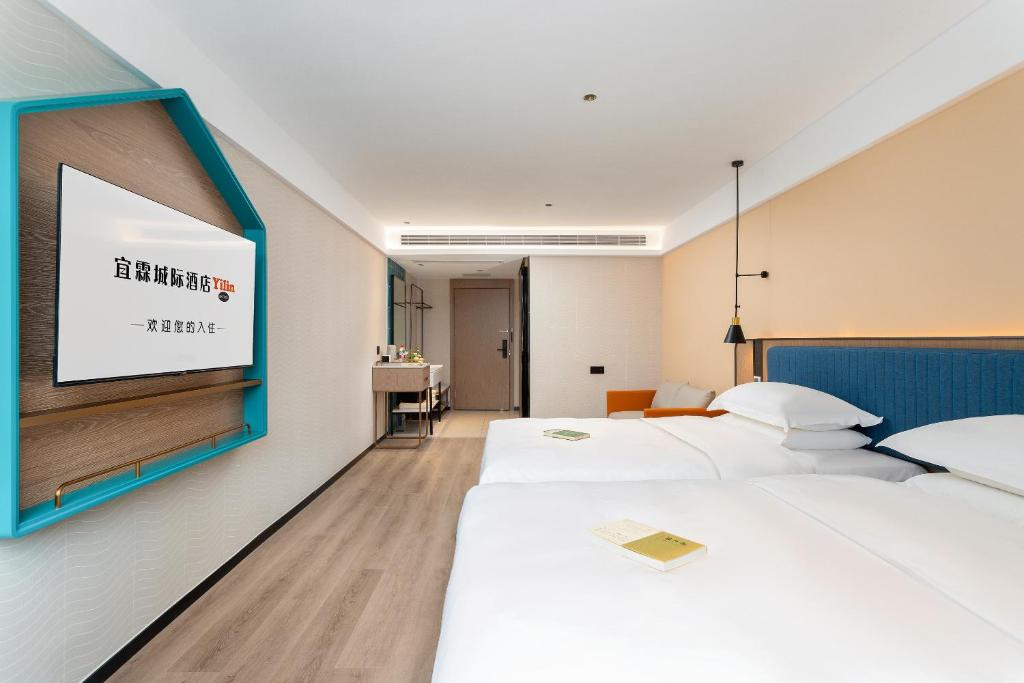 Postel nebo postele na pokoji v ubytování Guangzhou Yilin Hotel - Xiaogang metro Store
