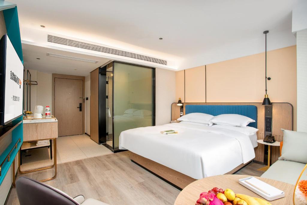 Postel nebo postele na pokoji v ubytování Guangzhou Yilin Hotel - Xiaogang metro Store
