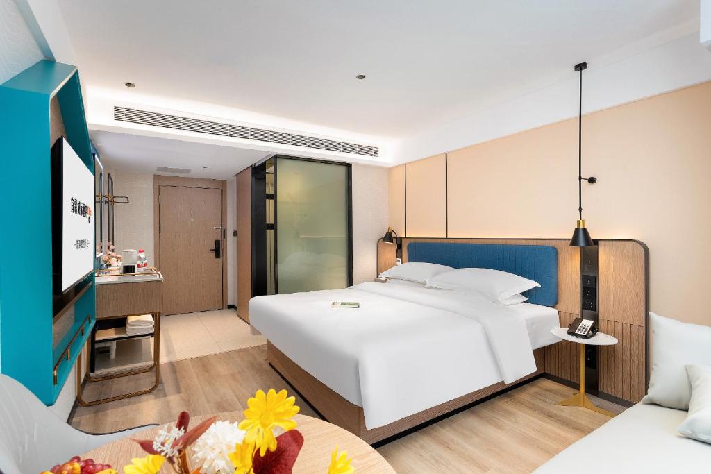 Postel nebo postele na pokoji v ubytování Guangzhou Yilin Hotel - Xiaogang metro Store