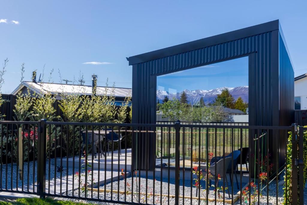 a gate in a garden with mountains in the background at Ben Ohau Views The Studio in Twizel