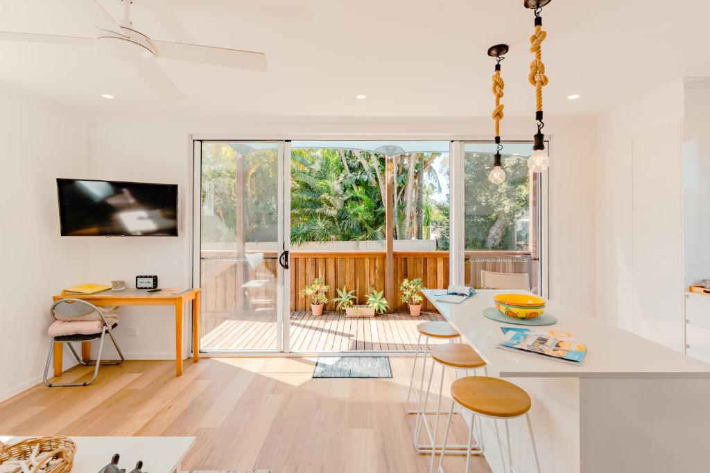 a kitchen with a table and chairs and a large window at Private and peaceful house near the Beach in Coolum Beach