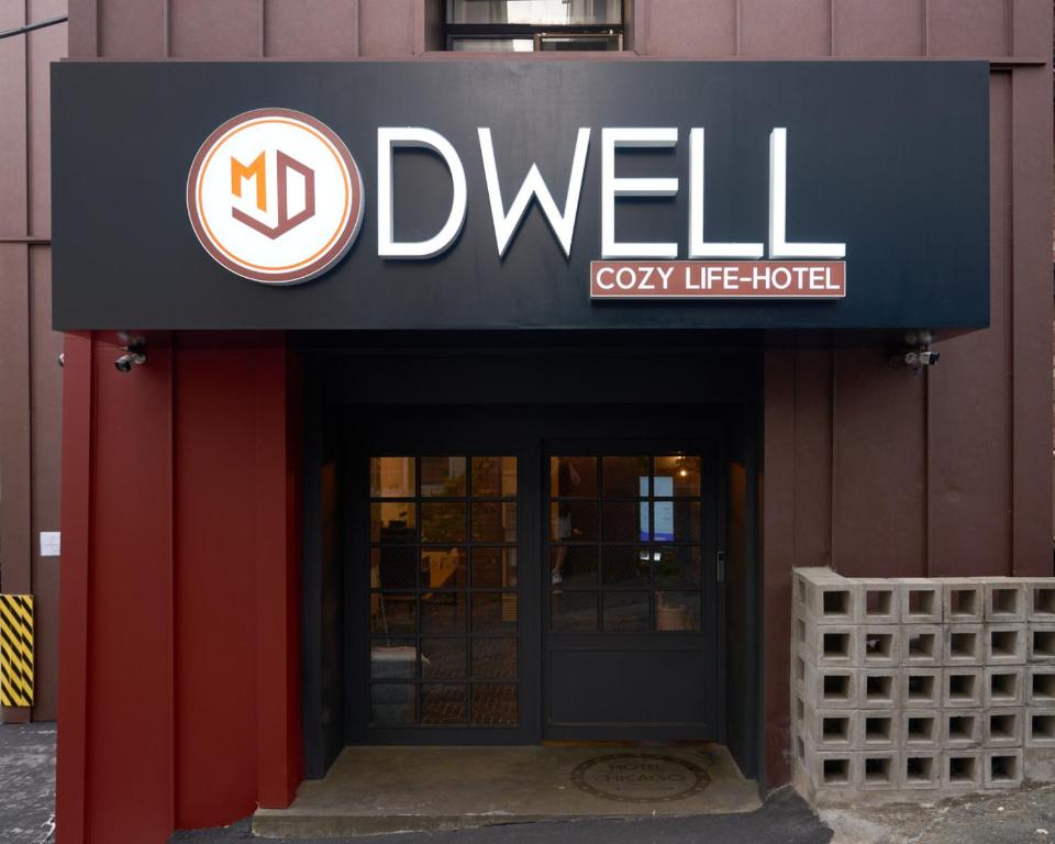a sign for a drywell restaurant on a building at D Well Hotel in Busan