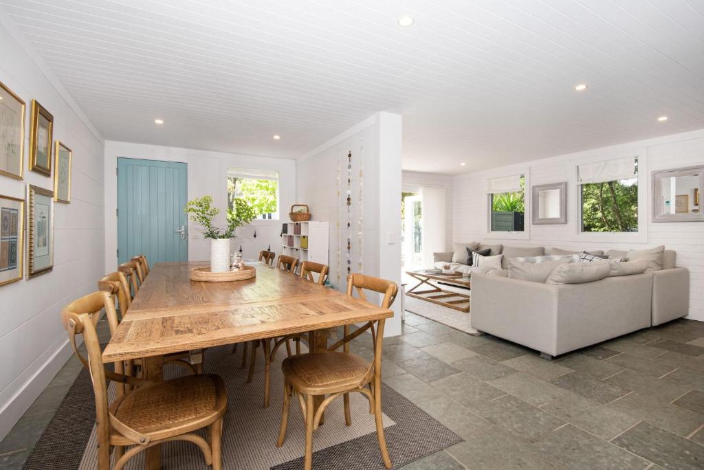 a dining room and living room with a table and chairs at Luxe on Ellesmere in Blairgowrie in Blairgowrie