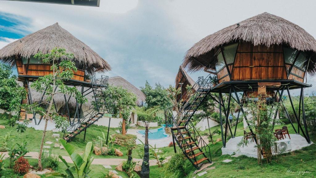 a resort with a tree house and a slide at Emo Coffee Home - Venuestay in Dak Lak