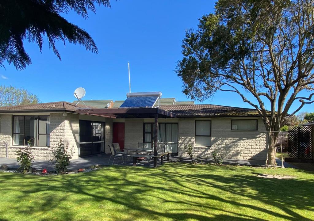a house with a solar panel on the roof at 4bed 2bath house 5 mins walk to Palms & Golf club in Christchurch