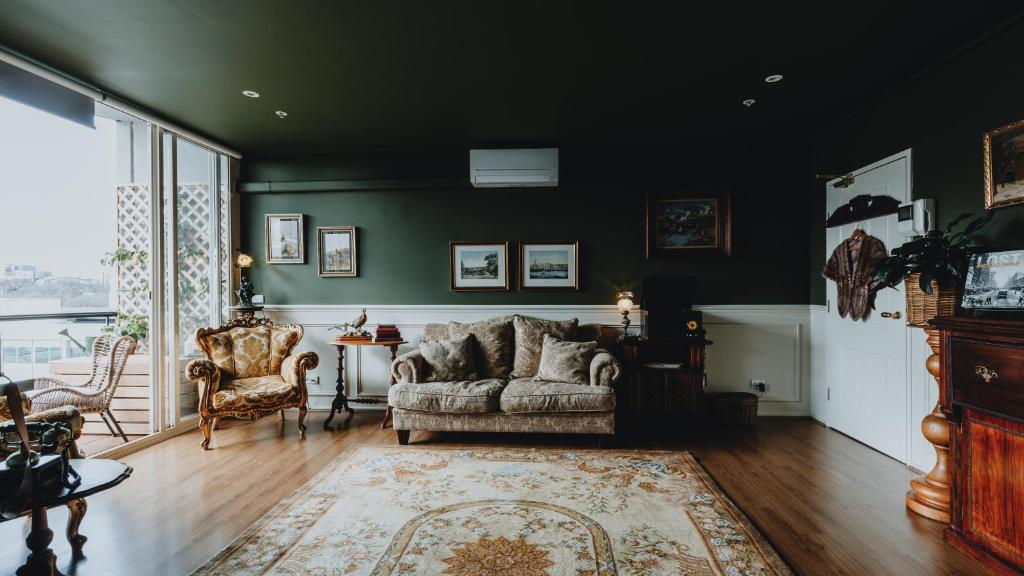 a living room with a couch and a table at Elegant apartment with balcony and free parking in Melbourne