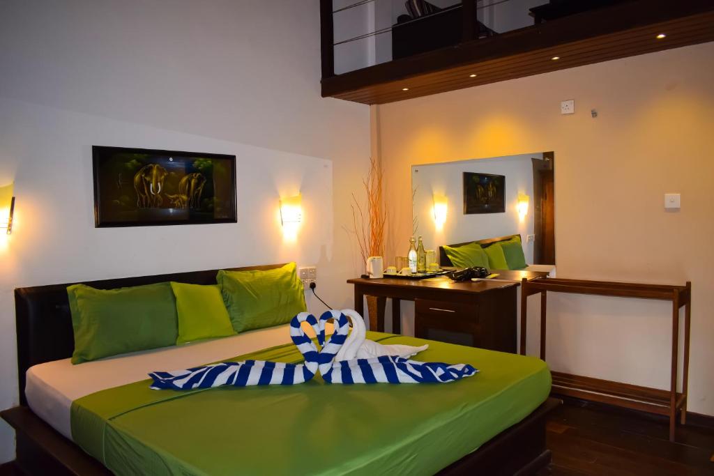 Postel nebo postele na pokoji v ubytování Hotel Green Garden