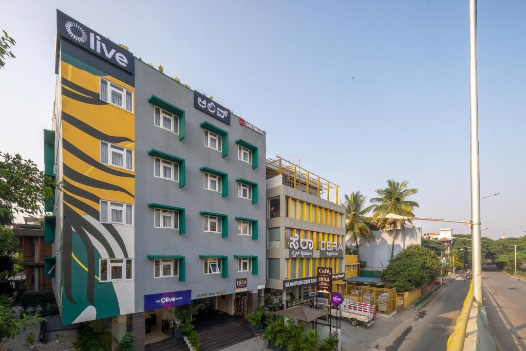 a building with a colorful facade on a street at Olive JP Nagar - by Embassy Group in Bangalore