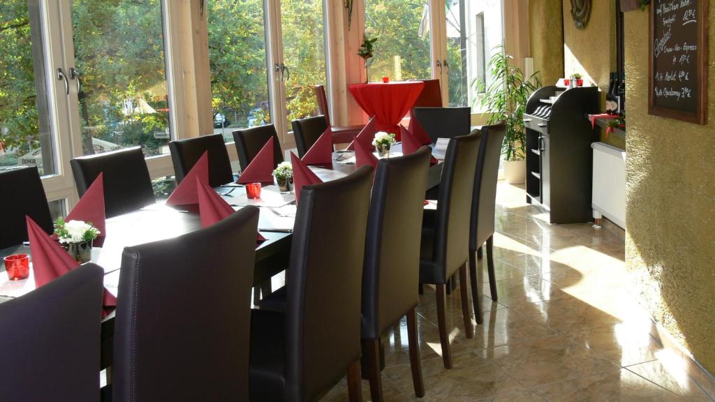 a dining room with tables and chairs with red napkins at Hotel Rössle in Freiberg am Neckar